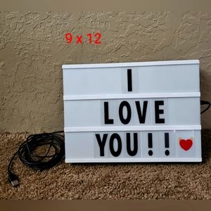 Light up sign with letters and emojis